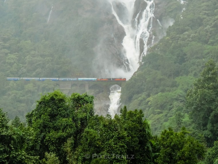 Amaravati Express getting a shower as it glides past Dudhsagar Waterfalls